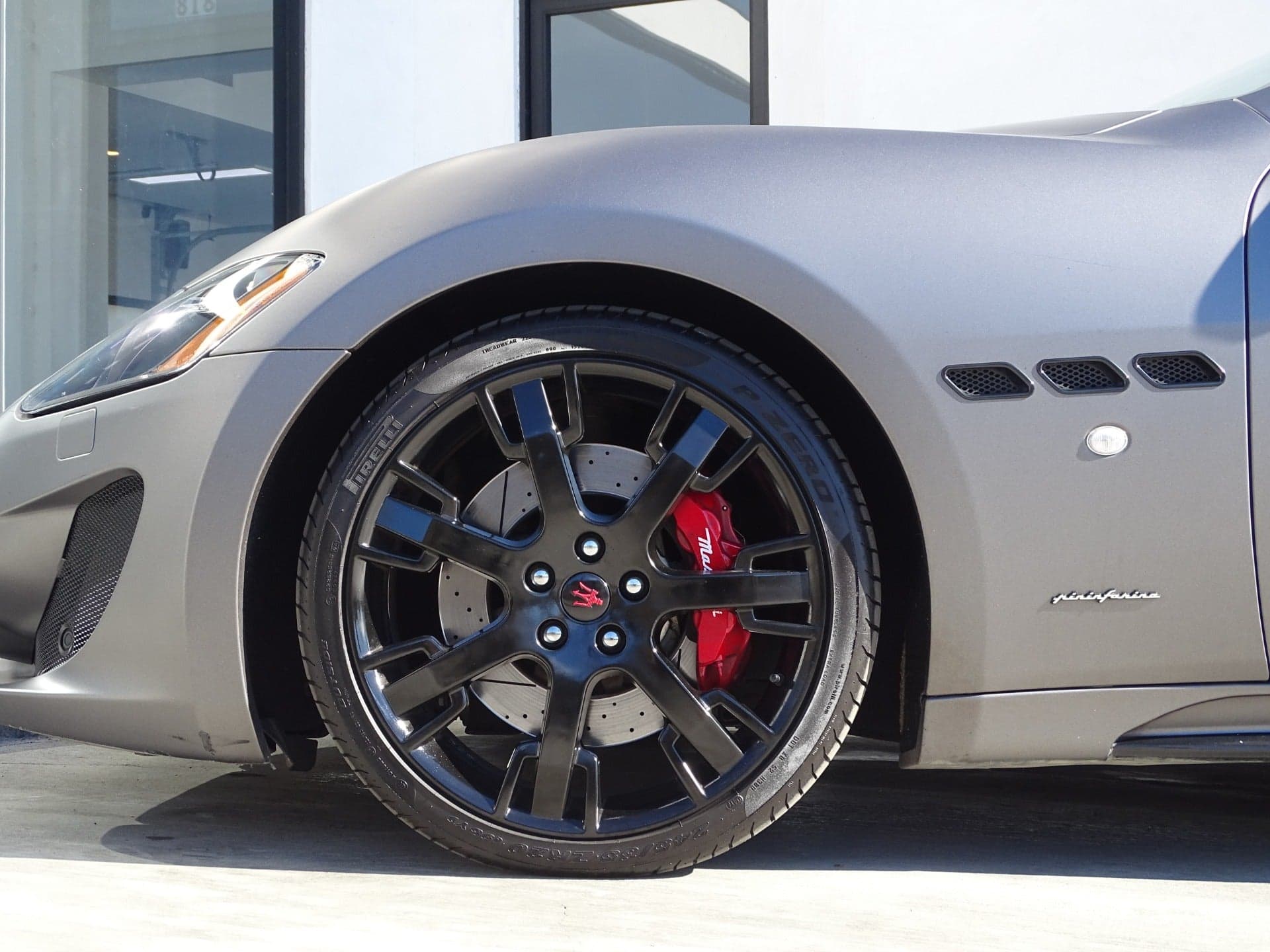 Big brake kit installed behind the wheel of a Maserati GranTurismo